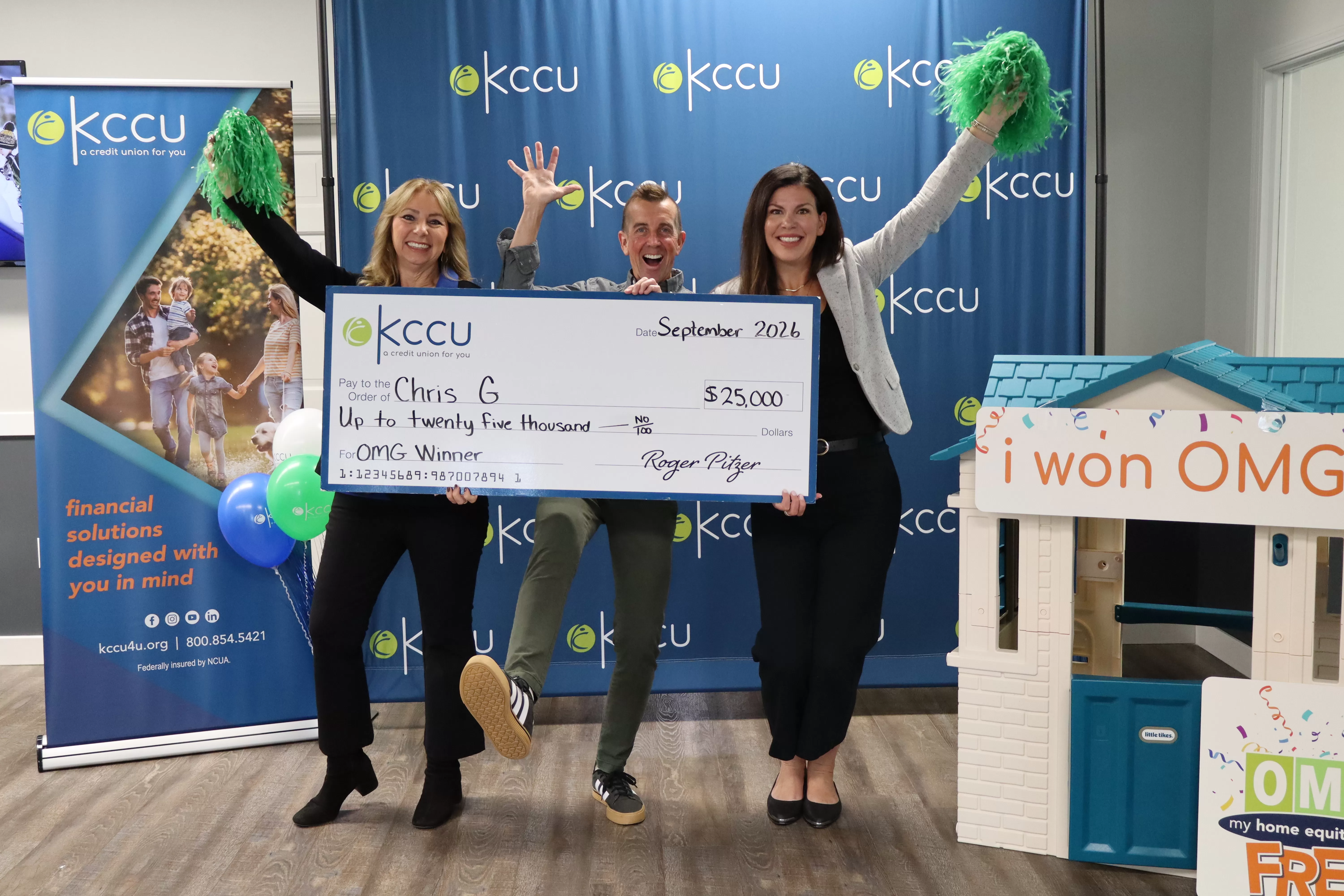 OMG winner Chris, Tracy and Lindsey from SLT holding big check and cheering
